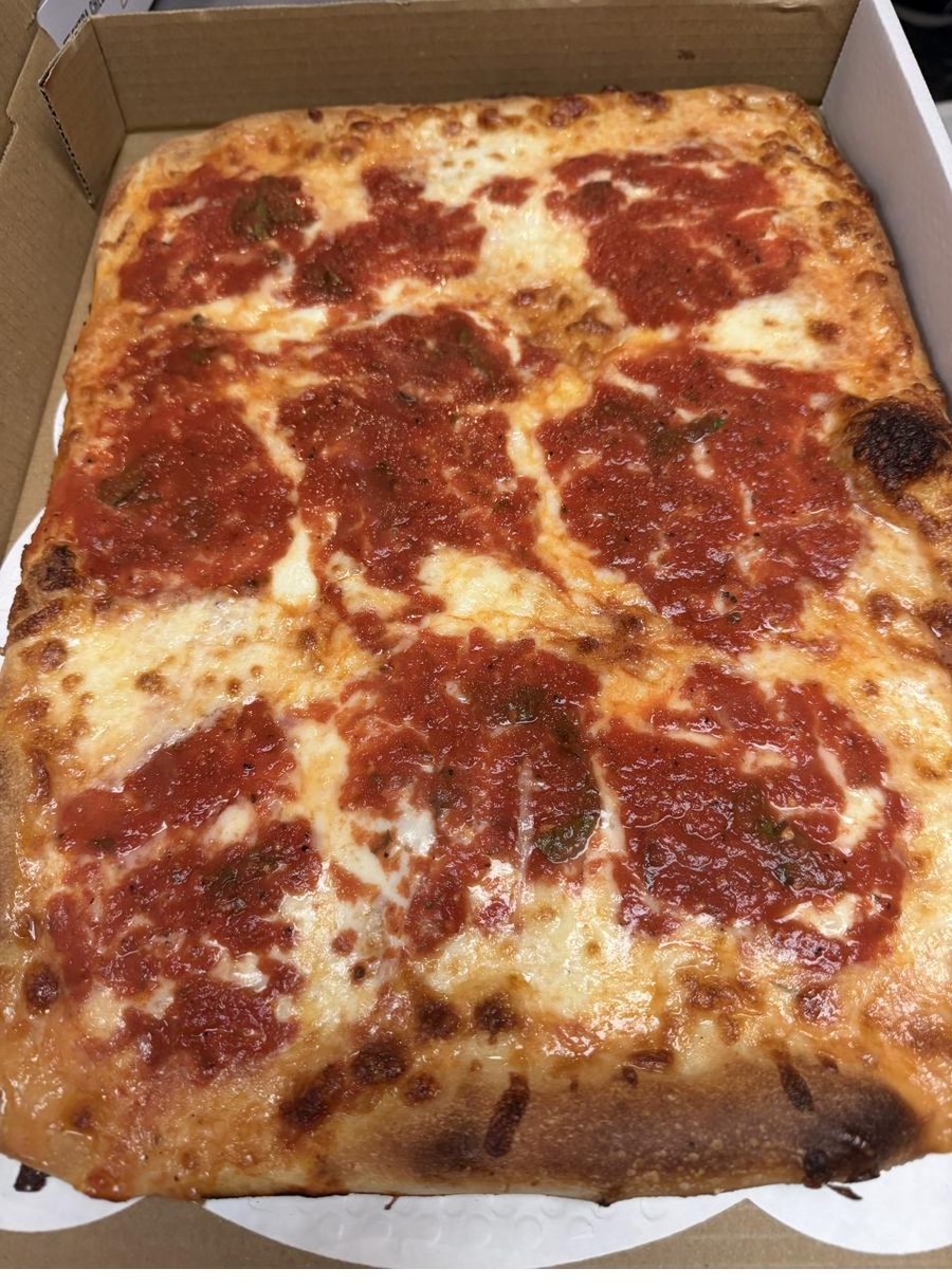 A full tray of pizza ready for a party